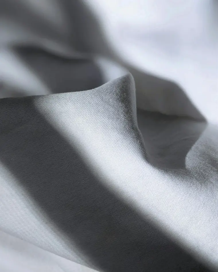 Close-up visual reference of softly folded cotton-blend fabric