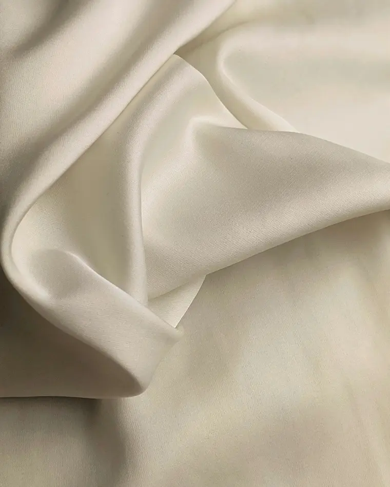 Close-up visual reference of softly draped ivory silk