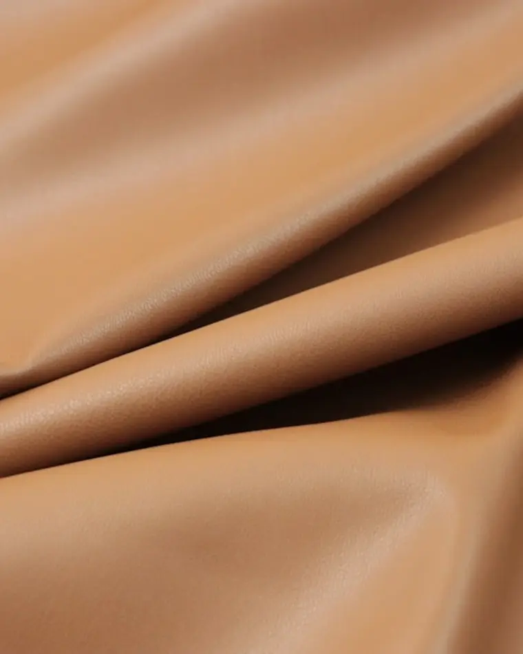 Close-up visual reference of warm camel suede
